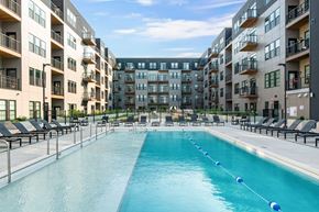 Madison apartment for rent - an apartment complex with a swimming pool in front of a building